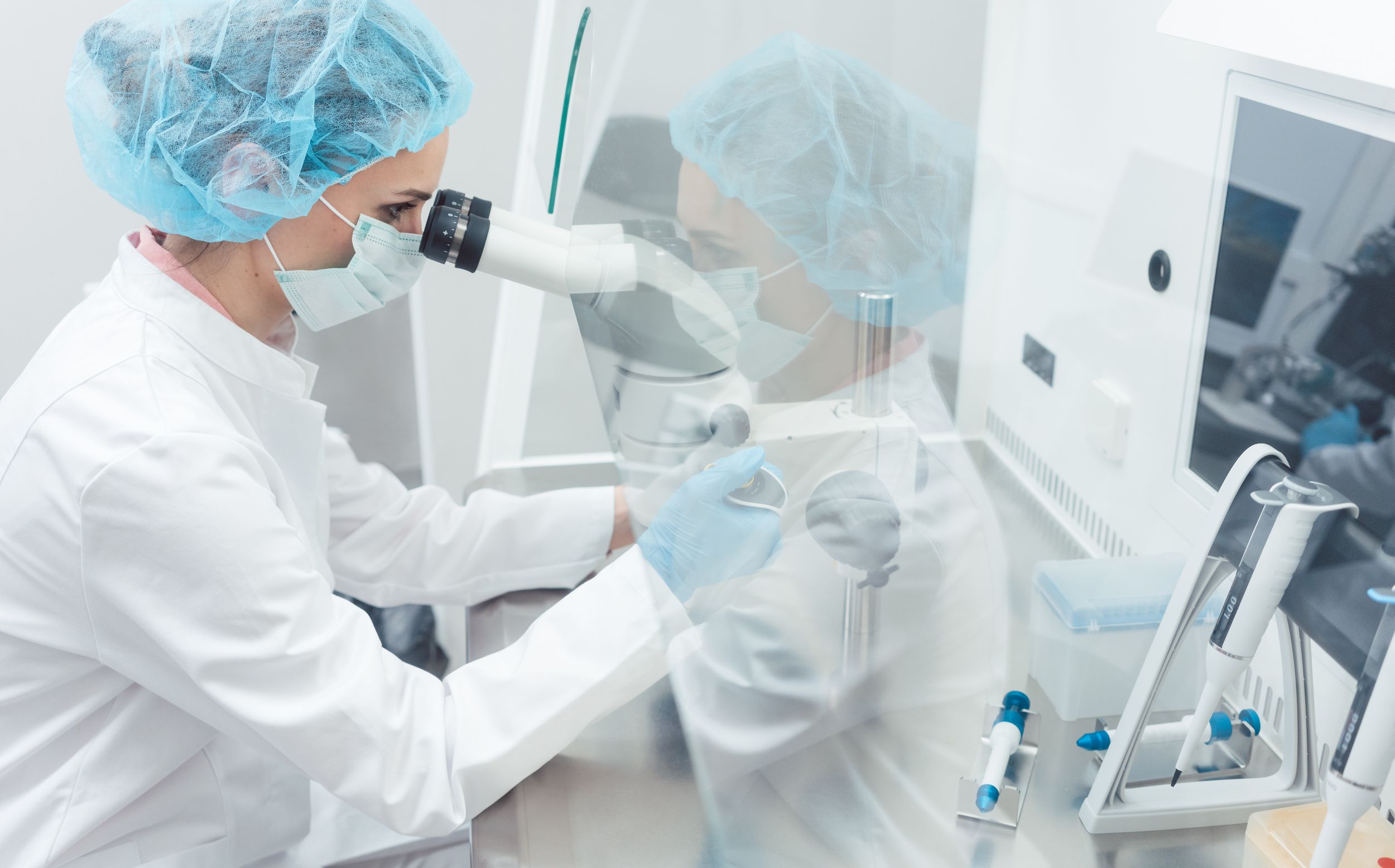 Woman using microscope in lab